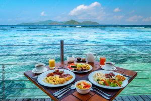 Breakfast on the beach by the pool with a look over the ocean of La Digue Seychelles,tropical Island