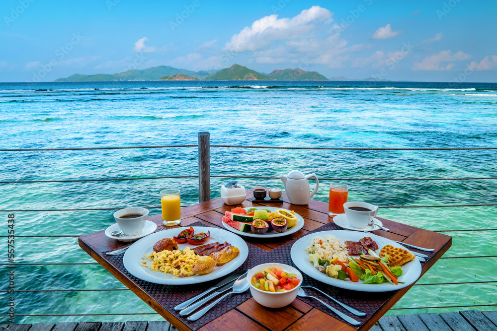 Breakfast on the beach by the pool with a look over the ocean of La Digue Seychelles,tropical Island